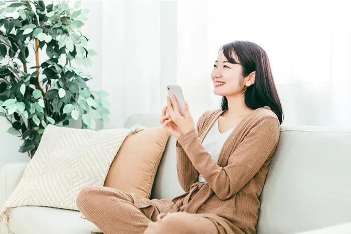 スマホで片づけを進める女性